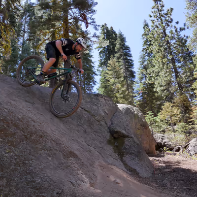 Collin rides down a granite slab on his hardcore hardtail.