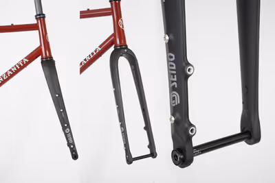 A tube showing the sample paint scheme of ruby red with baby blue graphics