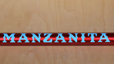 A tube showing the sample paint scheme of ruby red with baby blue graphics