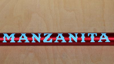 A tube showing the sample paint scheme of ruby red with baby blue graphics